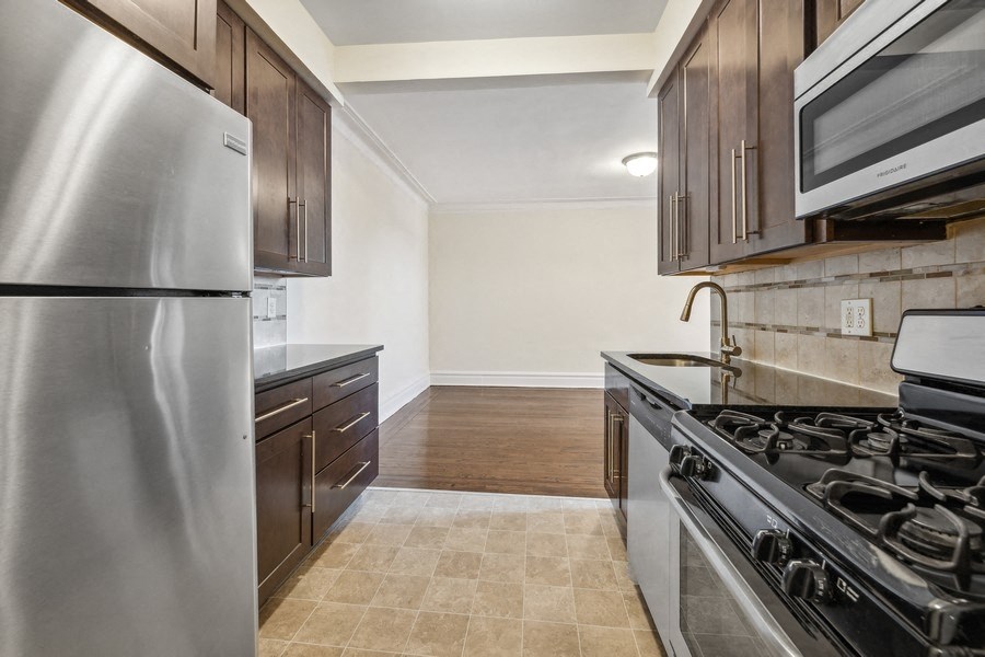 a kitchen with stainless steel appliances and wooden cabinets