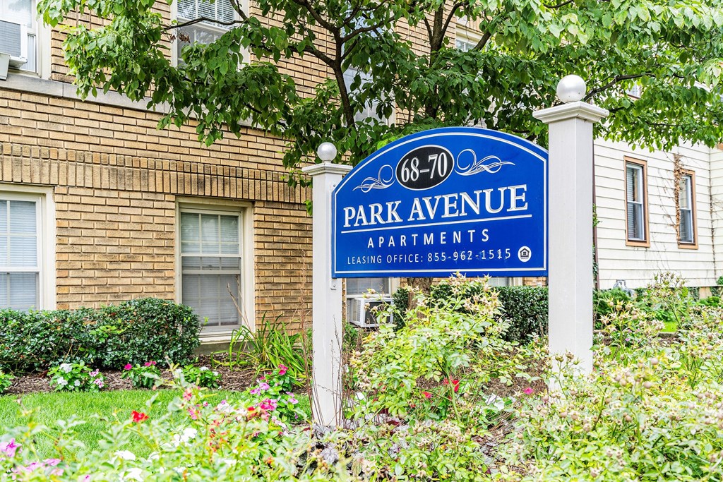 a park avenue apartments sign in front of a brick building