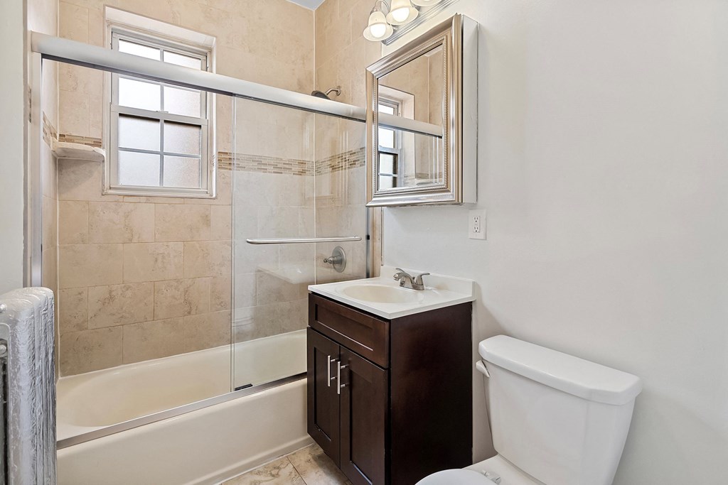 a bathroom with a toilet sink and shower