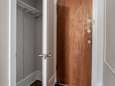a wooden door in a room with a closet