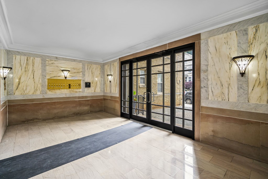 a lobby with a door and marble walls