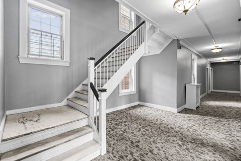the entryway of a house with stairs and a window