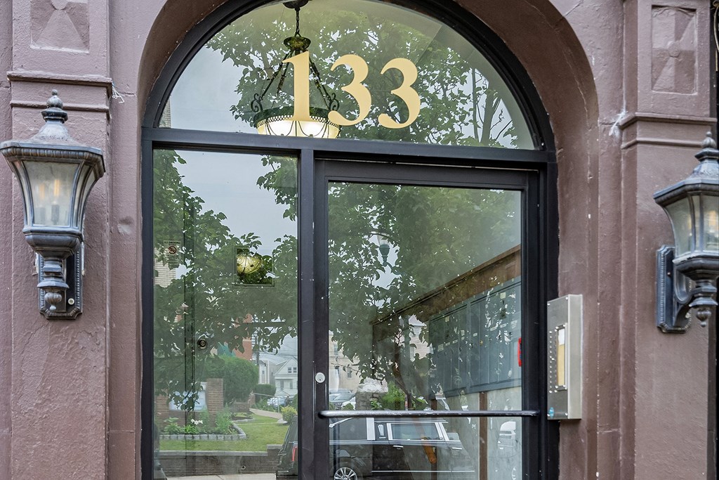 the front of a building with a window with the number 133 on it