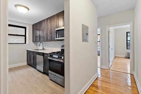 an empty kitchen with a stove and a microwave