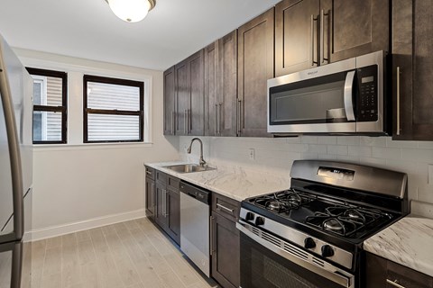 a kitchen with stainless steel appliances and wooden cabinets