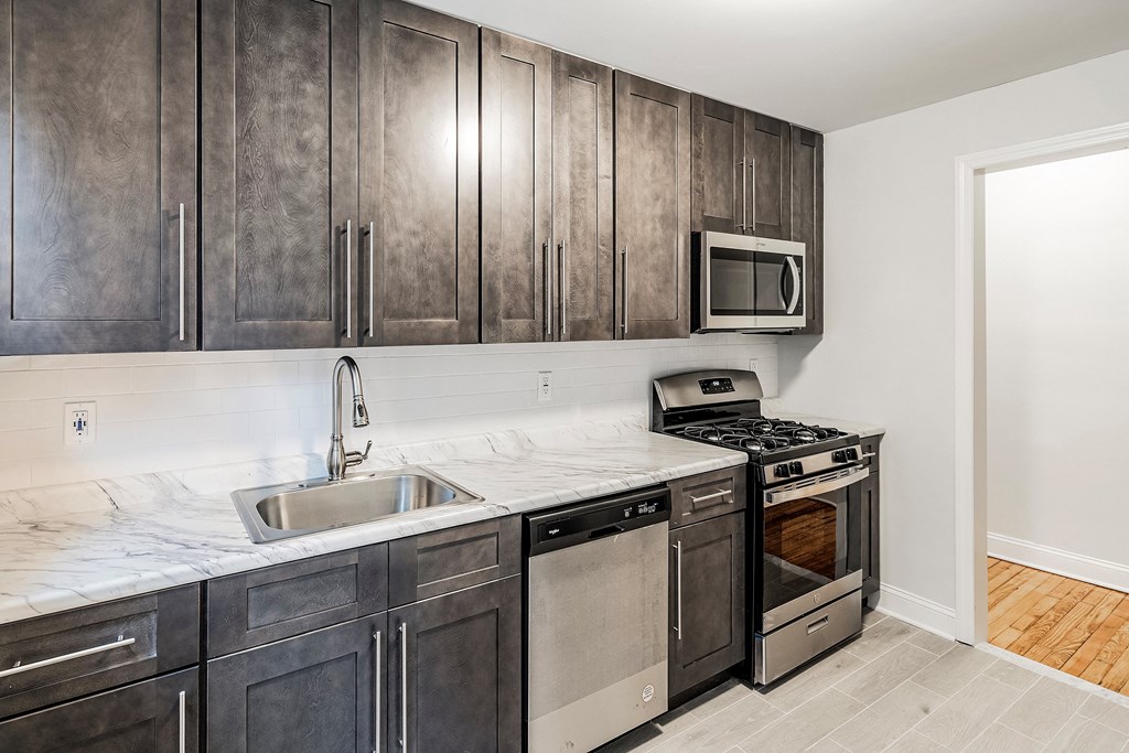 a kitchen with stainless steel appliances and wooden cabinets