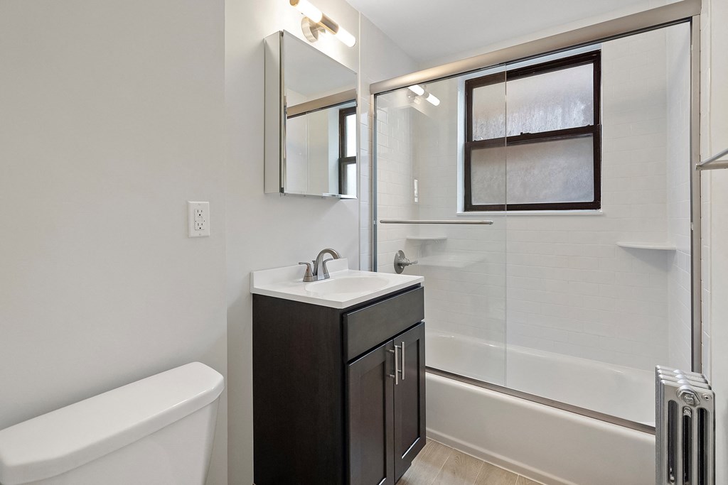 a bathroom with a sink and a shower and a mirror