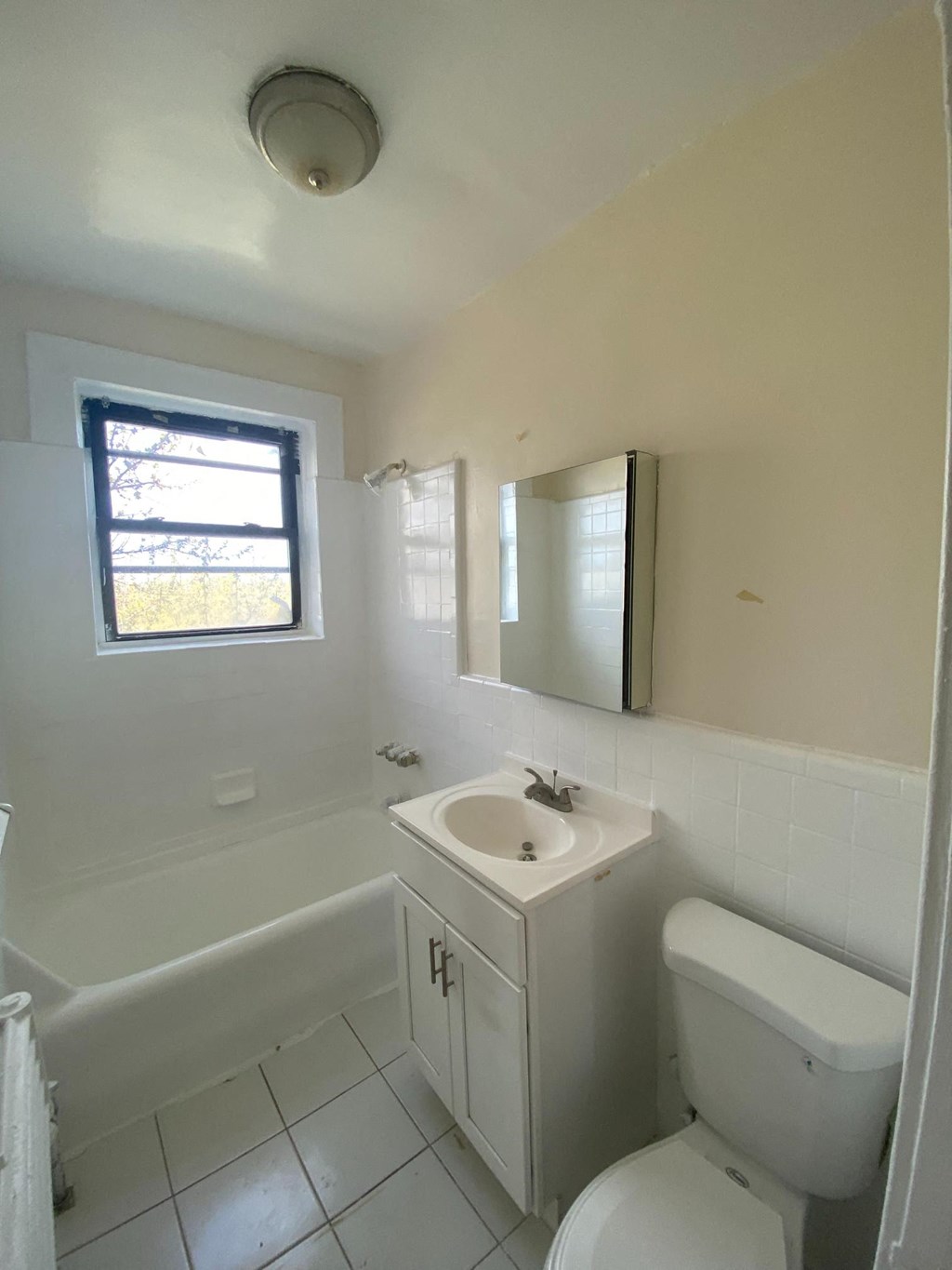 an empty bathroom with a sink toilet and tub