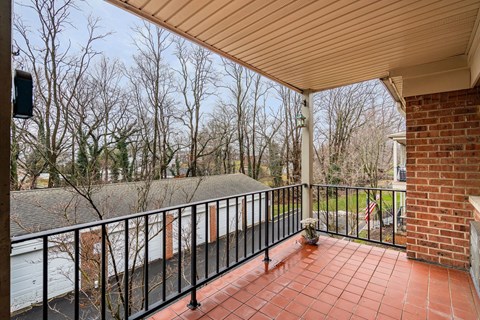 a balcony with a brick wall and a brick fireplace