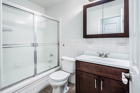 a bathroom with a toilet sink and shower