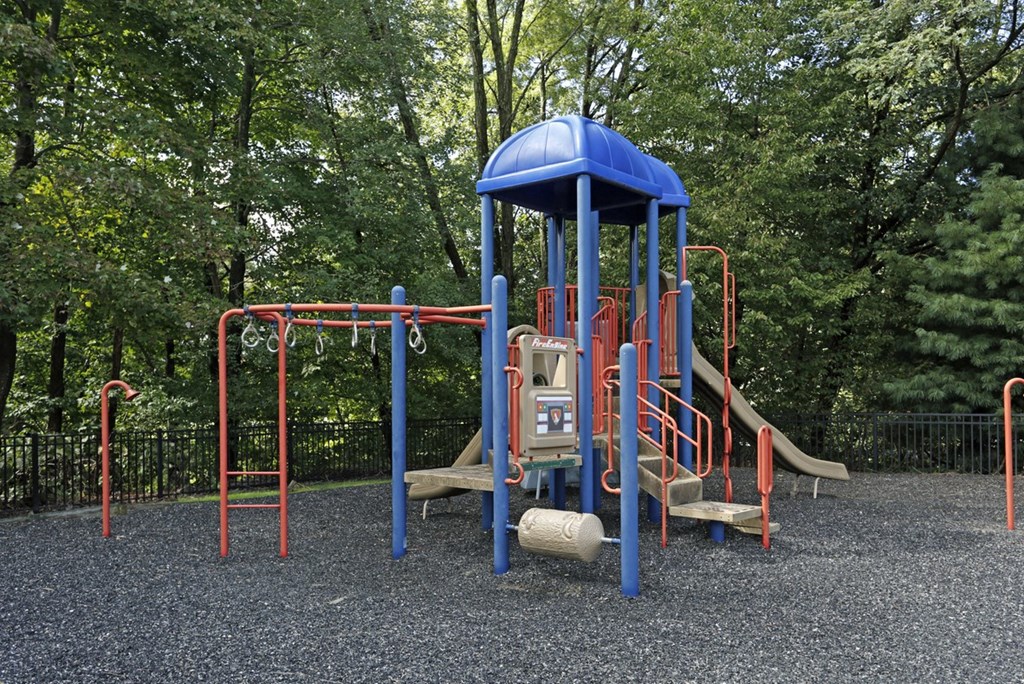 a playground with a blue swing set and other playground equipment