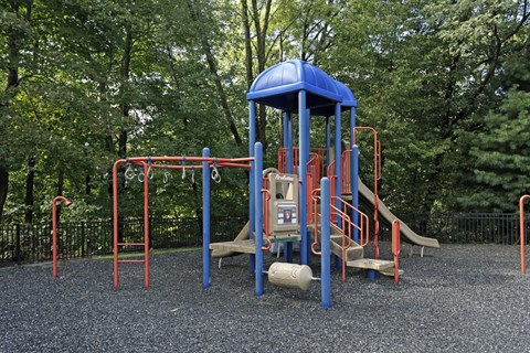 a playground with a blue swing set and other playground equipment