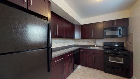 full kitchen with stainless steel appliances and dark wood cabinets