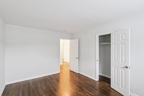 A room with white walls and a wooden floor.