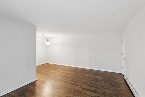 A room with wooden floors and white walls.
