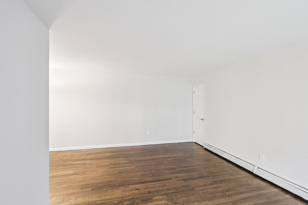 A room with wooden floors and white walls.