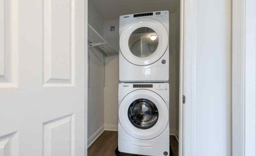 a front loading washer and dryer in a small laundry room
