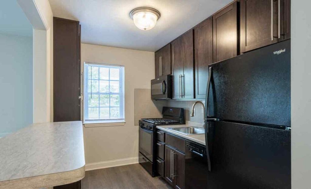 a kitchen with black appliances and a counter top