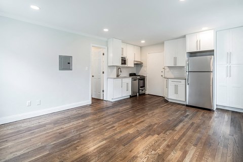 a renovated kitchen with white cabinets and stainless steel appliances