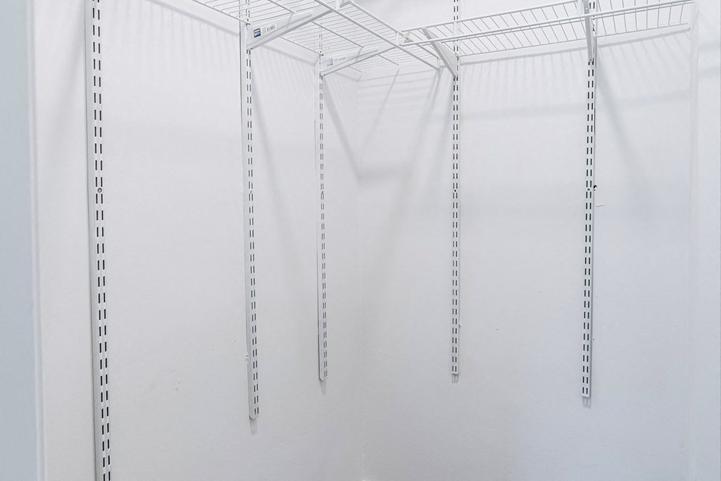 a group of clothes hangers hanging from a ceiling