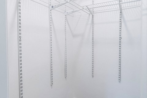 a group of clothes hangers hanging from a ceiling