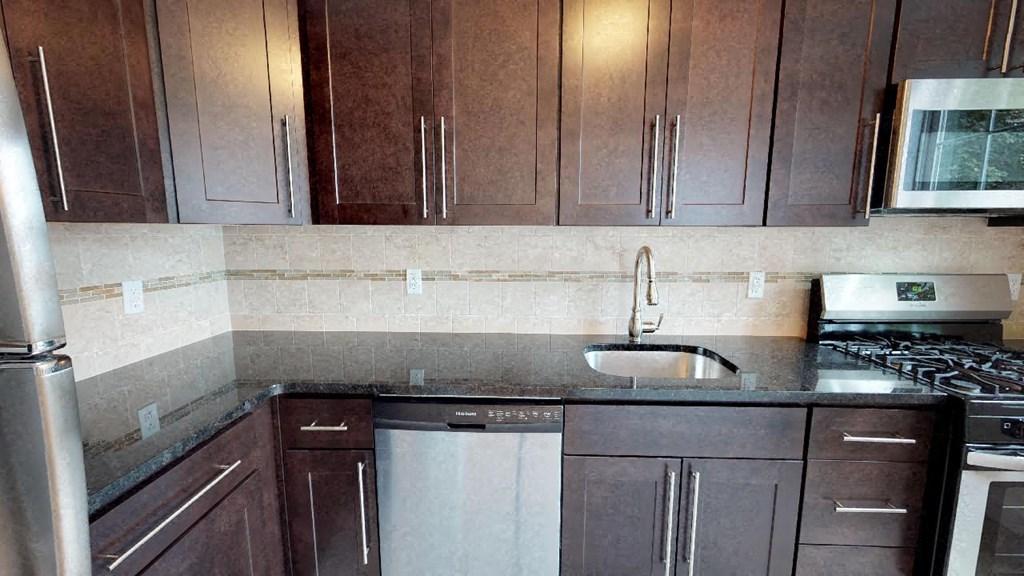 a kitchen with wooden cabinets and a sink