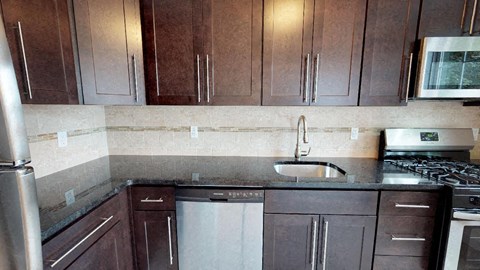 a kitchen with wooden cabinets and a sink