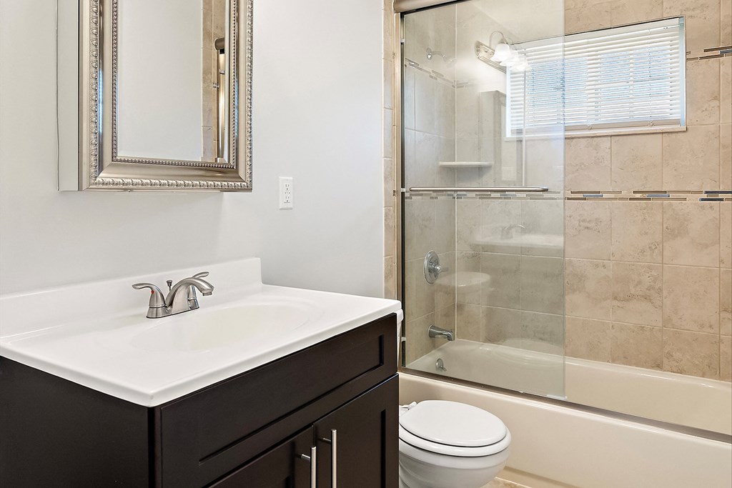 a bathroom with a sink and a shower and a toilet