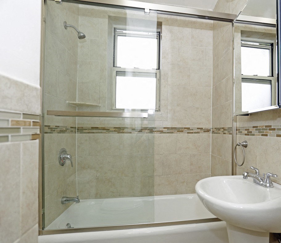 a bathroom with a sink and a shower and a bath tub