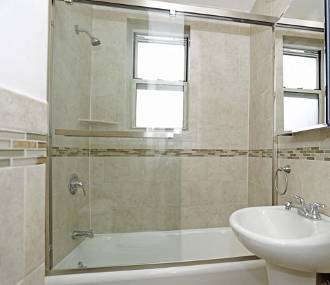 a bathroom with a sink and a shower and a bath tub
