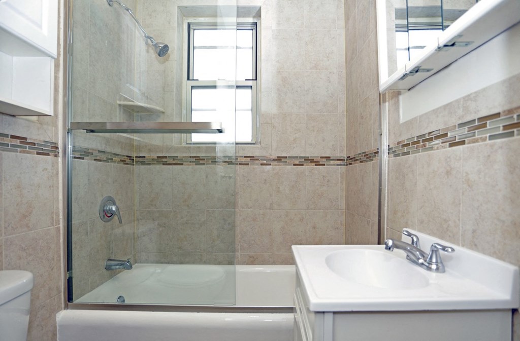 a small bathroom with a shower and a sink