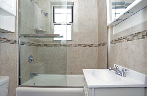 a small bathroom with a shower and a sink