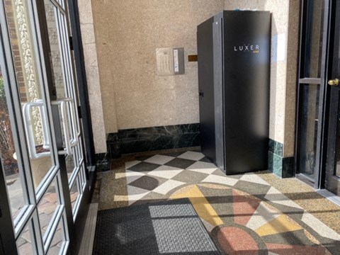the lobby of a building with a lift and a door