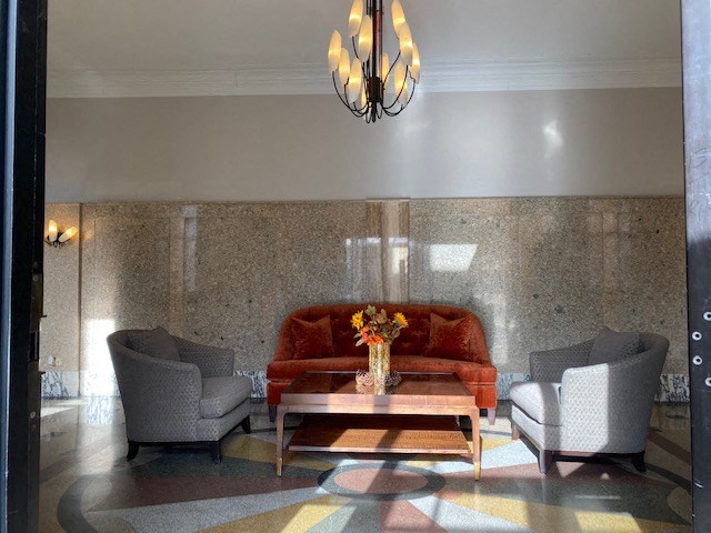 a living room with a couch and chairs and a table