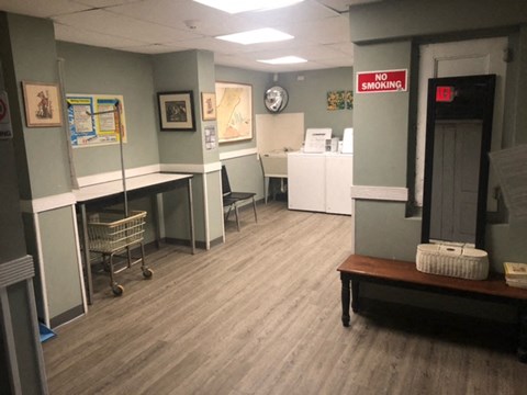 a room with a desk and a sign on the wall