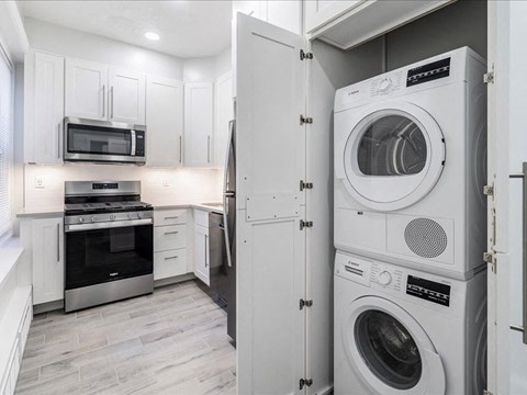 a white laundry room with a washer and a dryer