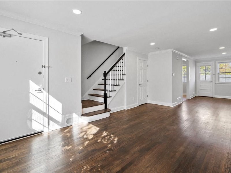 a living room with white walls and a wooden floor