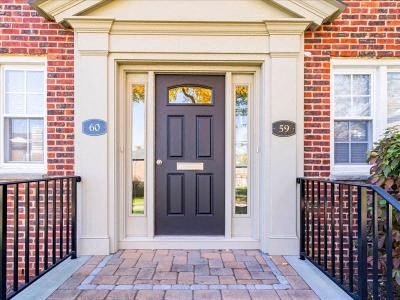 the front door of a brick house with a black door