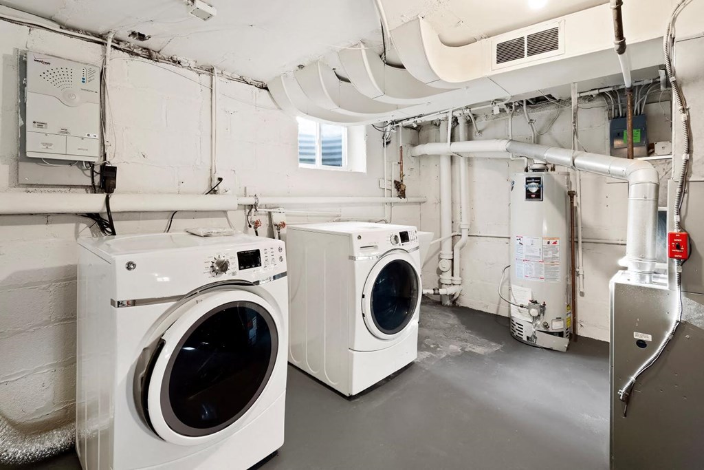 a laundry room with two washes and a dryer