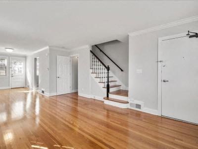 a living room with a hard wood floor and a staircase