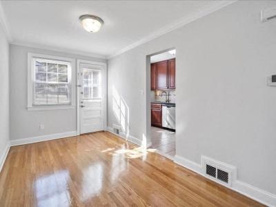 an empty living room with a hard wood floor