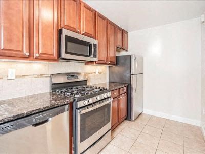 a kitchen with stainless steel appliances and wooden cabinets