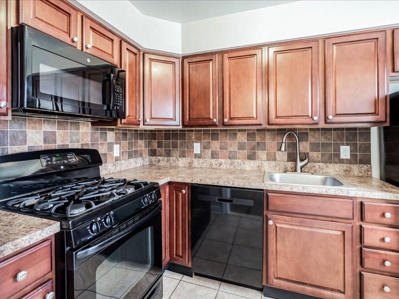 a kitchen with a stove microwave and sink