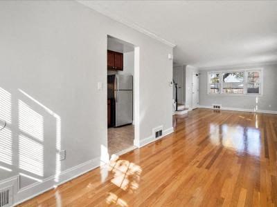 a empty living room with a hard wood floor