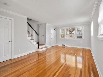 a living room with a hard wood floor and a staircase