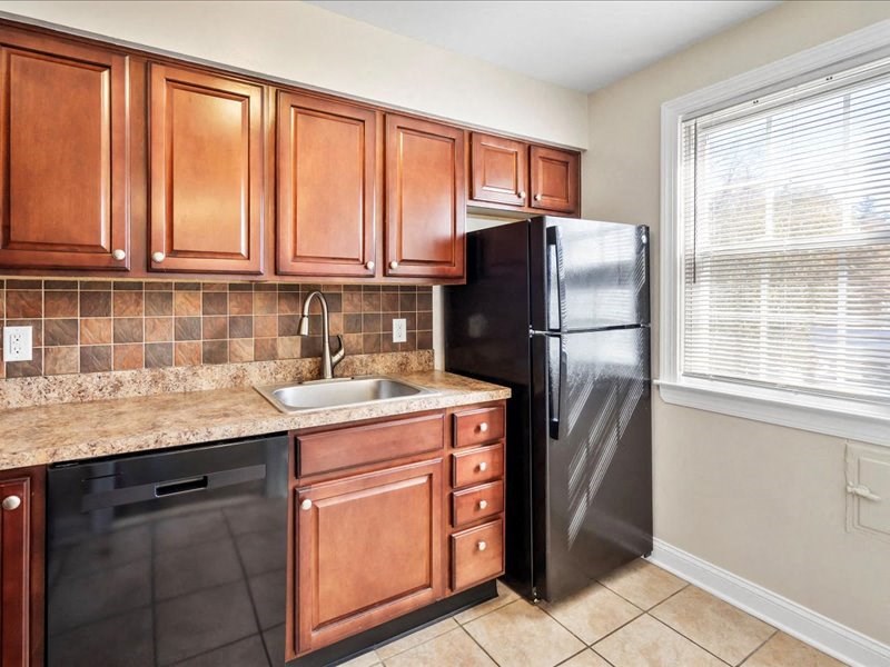 a kitchen with a sink and a refrigerator