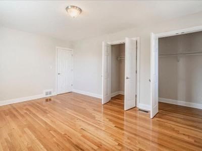 a empty room with a wooden floor and a closet