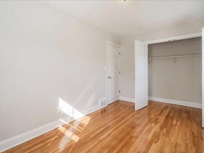 a empty room with a wooden floor and a white door
