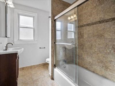 a bathroom with a shower and a tub and a sink
