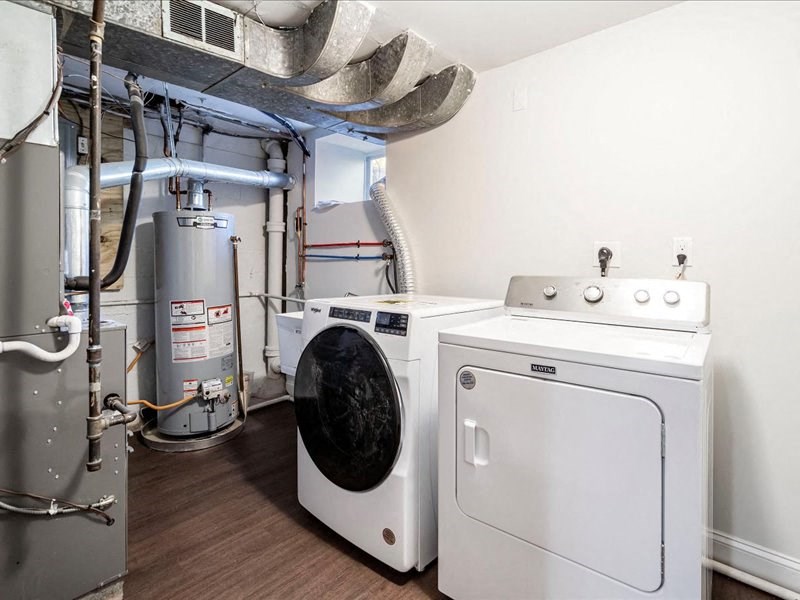 a laundry room with two washers and a washing machine